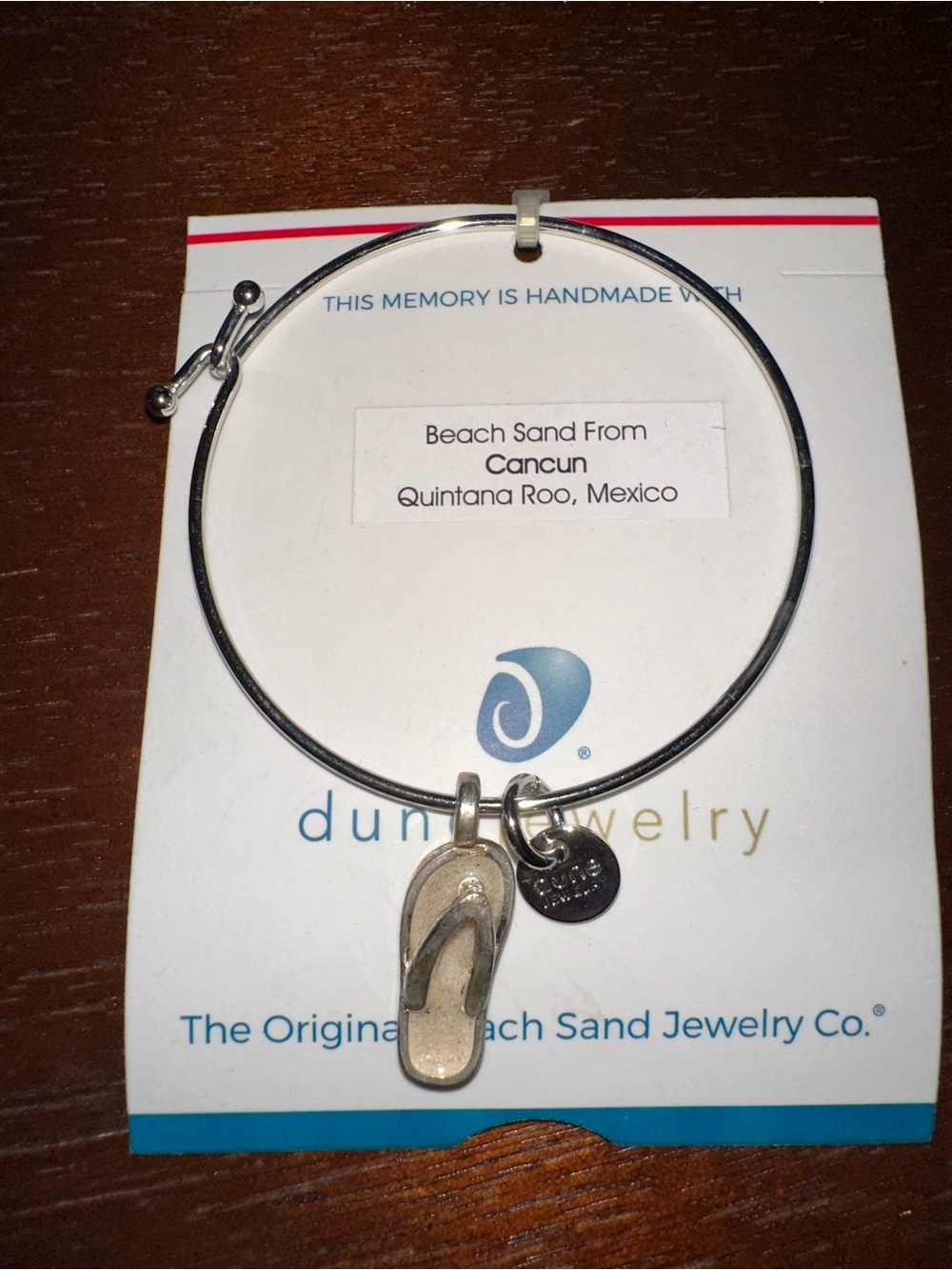 Dune Jewelry Silver Flip-Flop Bangle w/Sand from Cancun Embedded in flip flop.